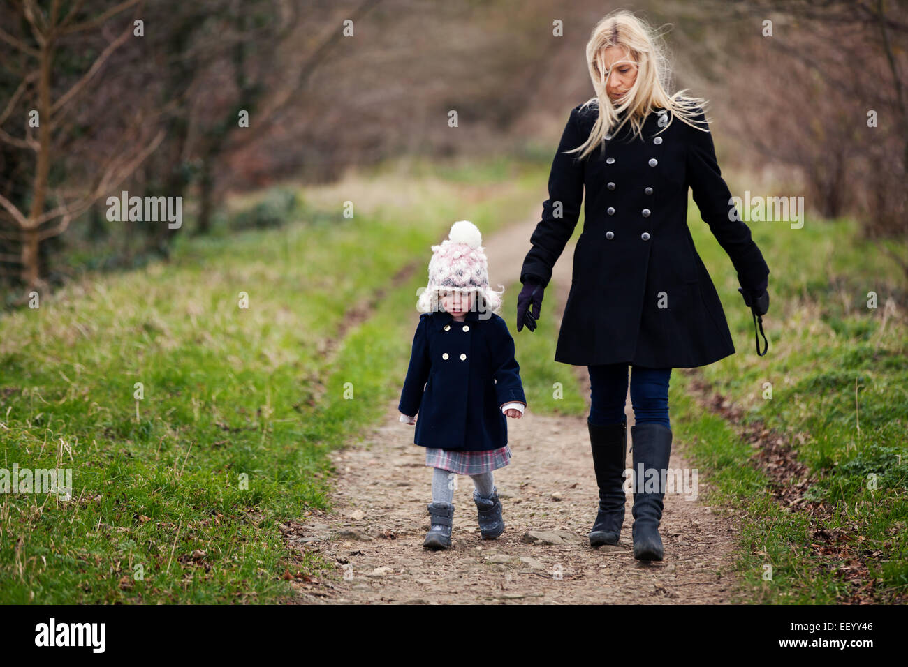 Mother and daughter on winter woodland walk Stock Photo