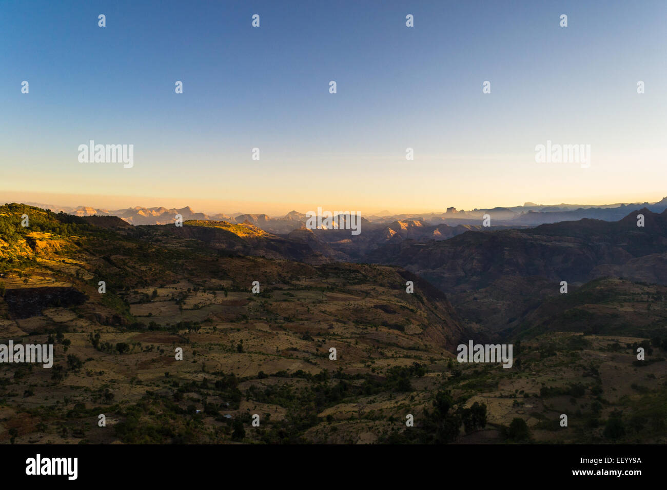 Wide angle view from the Simien Mountains on valleys and highlands in Tigray region, hit by the first golden sunlight. Northern  Stock Photo