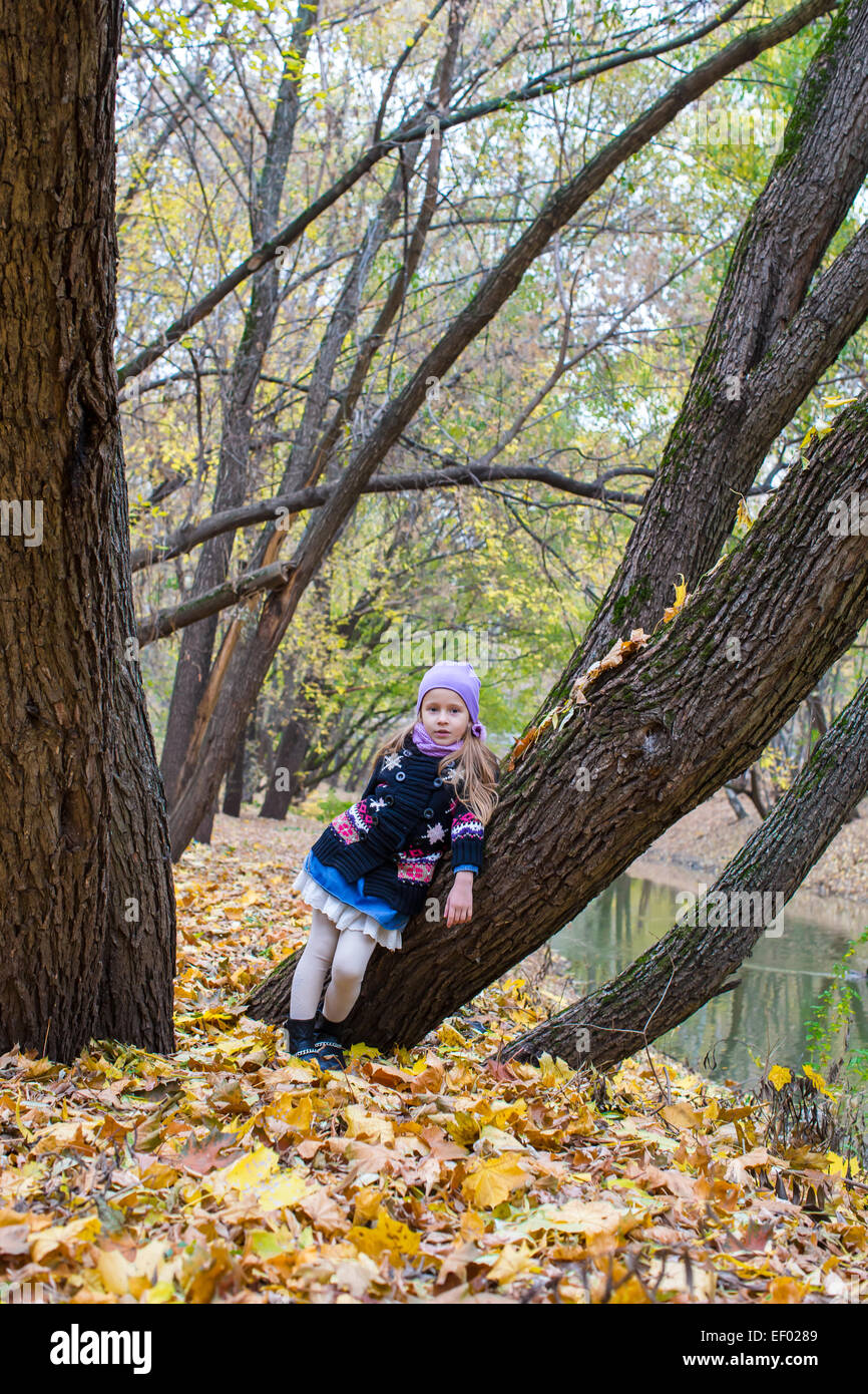 Little girl in autumn park on fall day outdoors Stock Photo - Alamy