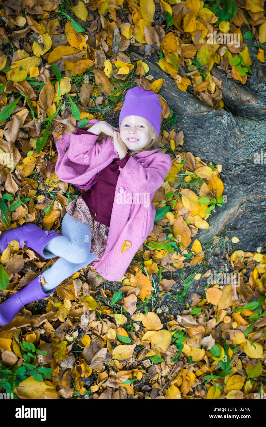 Little happy girl in autumn park outdoors Stock Photo - Alamy