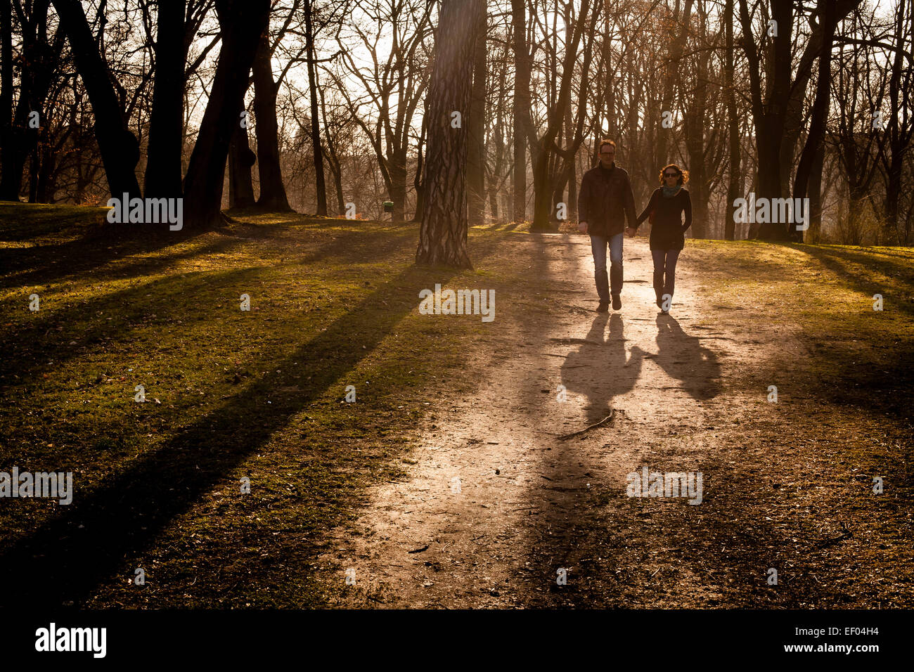 Middle aged couple walking through a park. Stock Photo
