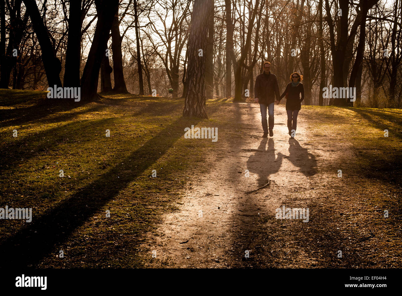 Middle aged couple walking through a park Stock Photo - Alamy