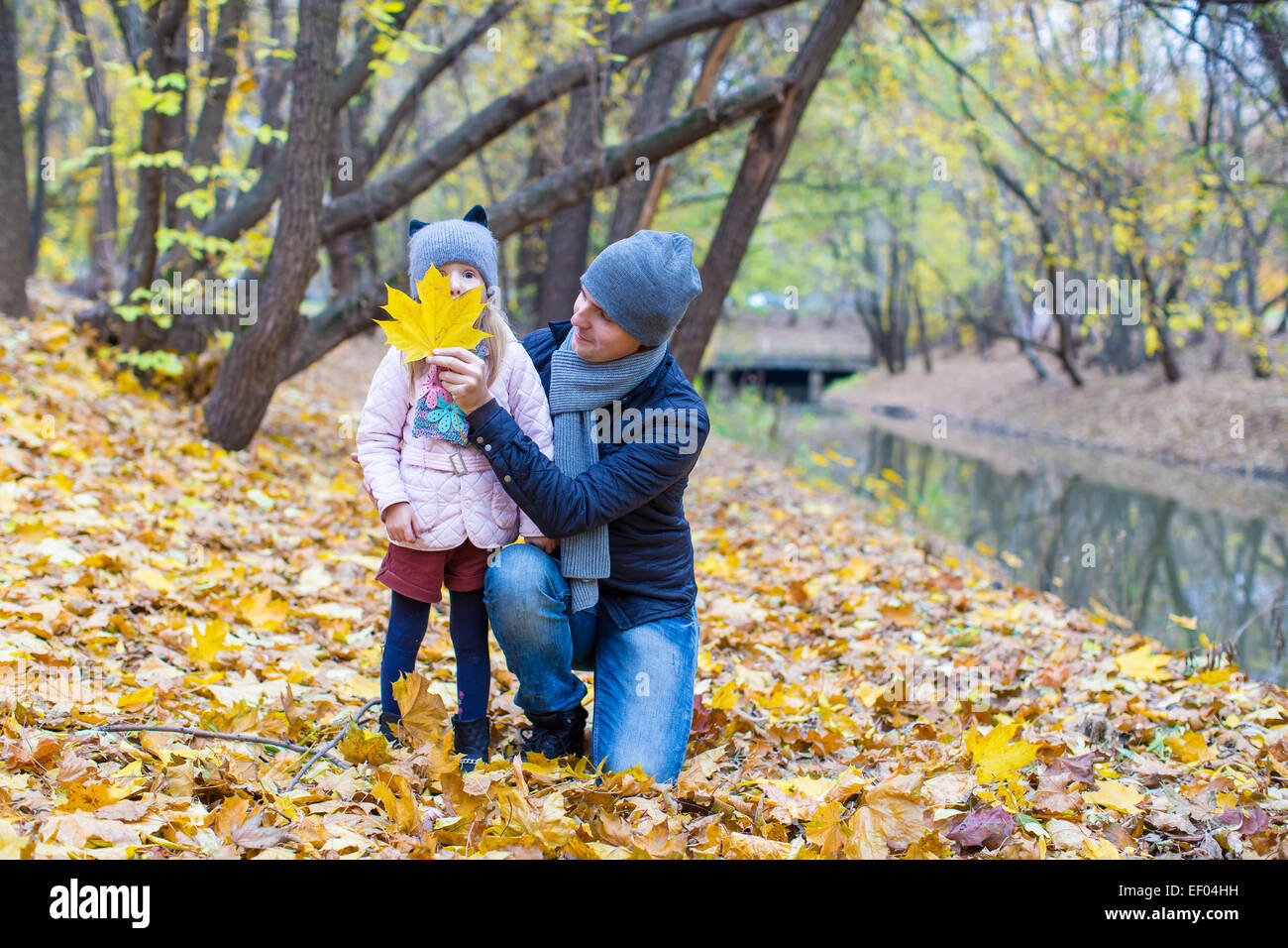 Little girl and dad in autumn park outdoors Stock Photo - Alamy