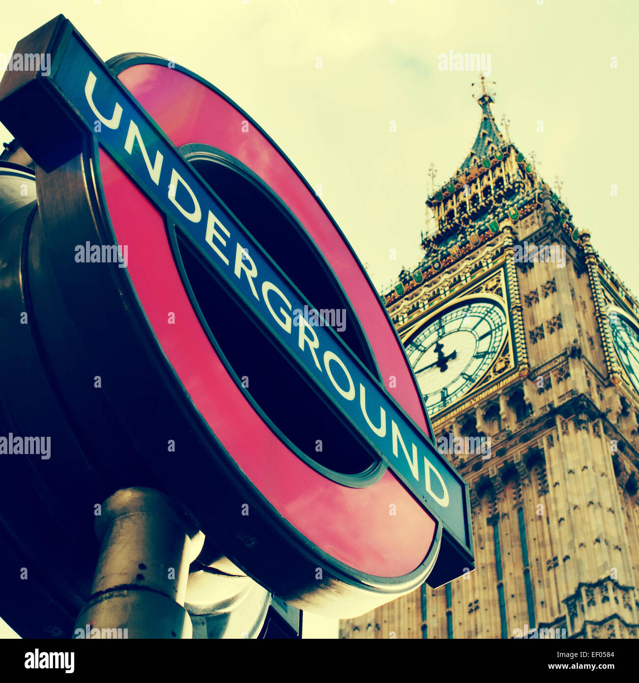 a view of a typical underground sign and the Big Ben in the background, in London, United Kingdom, with a filter effect Stock Photo