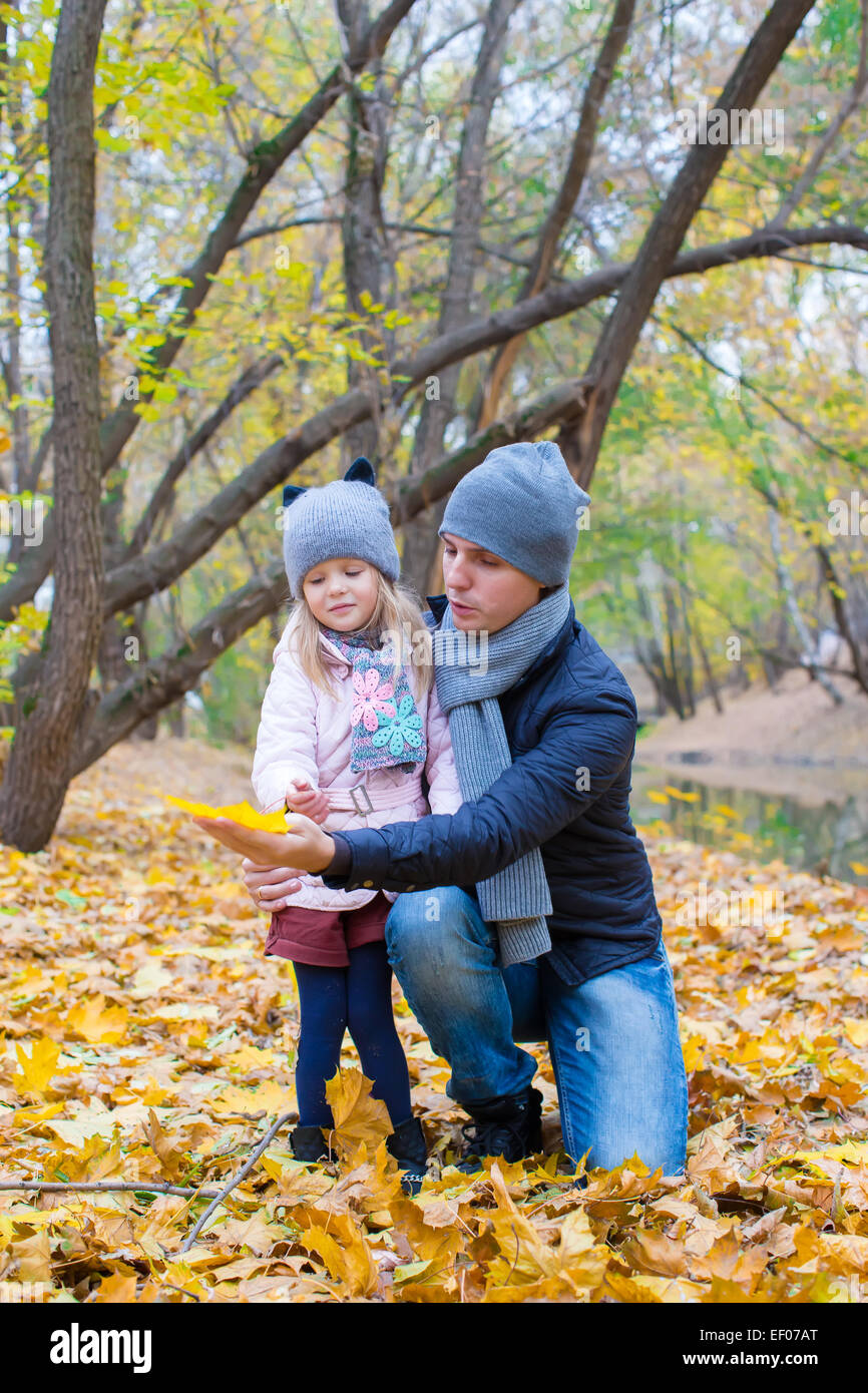 Little girl and dad in autumn park outdoors Stock Photo - Alamy