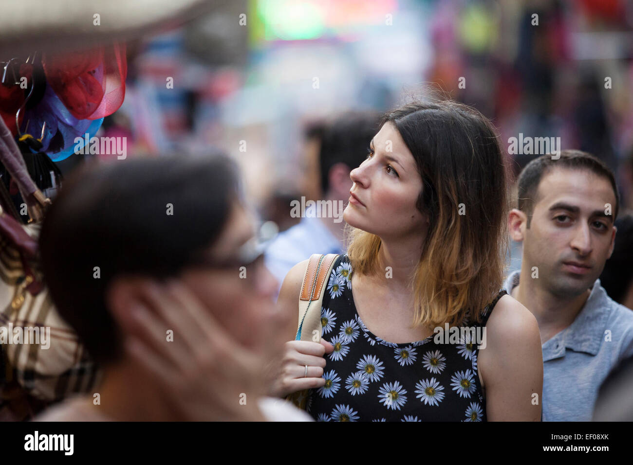 A woman shopping in a crowded street market in Hong Kong Stock Photo