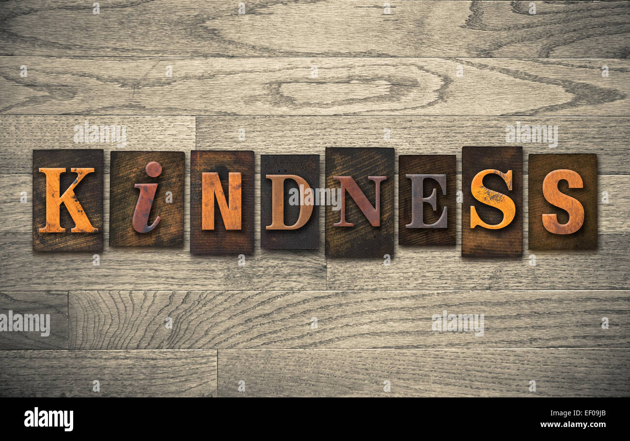 The word 'KINDNESS' written in vintage wooden letterpress type. Stock Photo