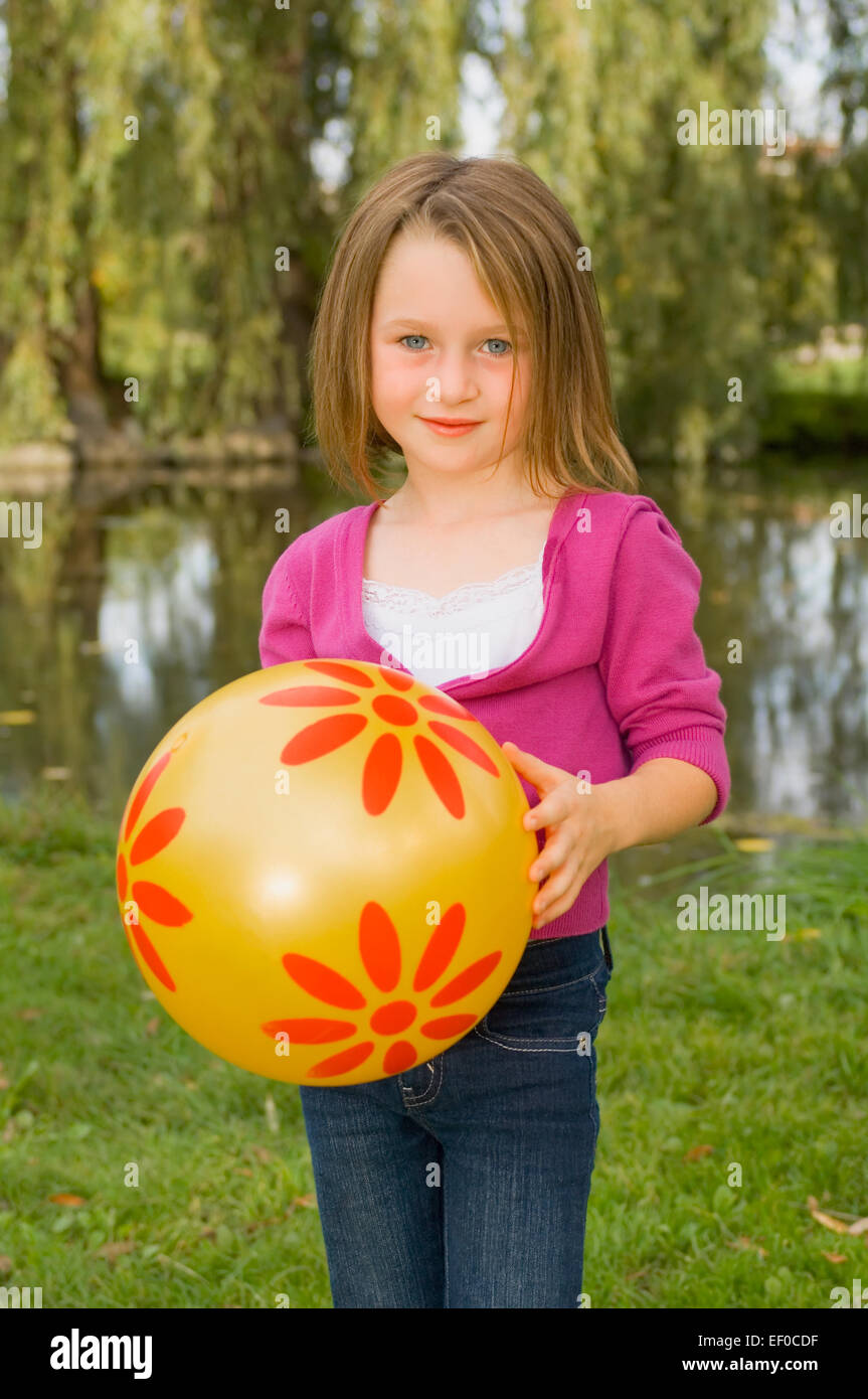 Young girl holding a beach ball Stock Photo Alamy