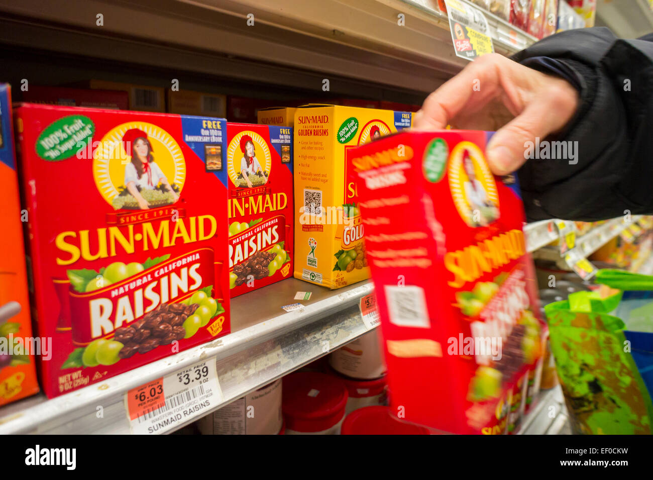 A shopper chooses a package of SunMaid California Raisins in a