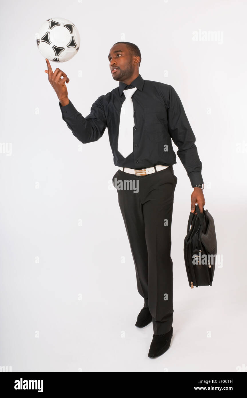 Businessman playing with a soccer ball Stock Photo - Alamy