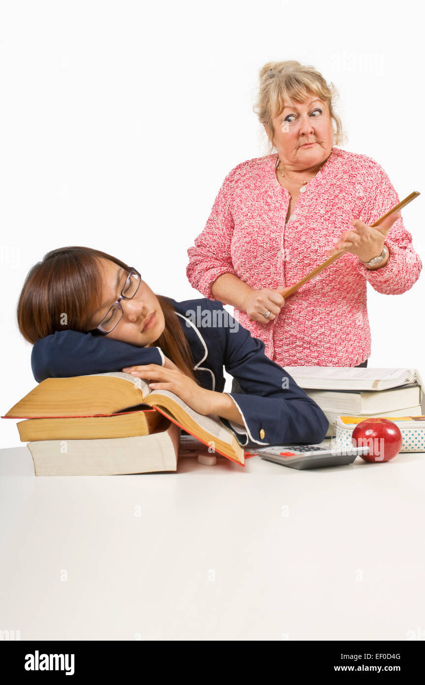 Angry teacher looking at sleeping student Stock Photo