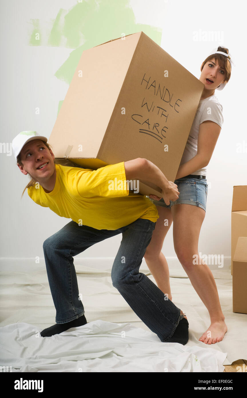 Couple lifting a big box Stock Photo