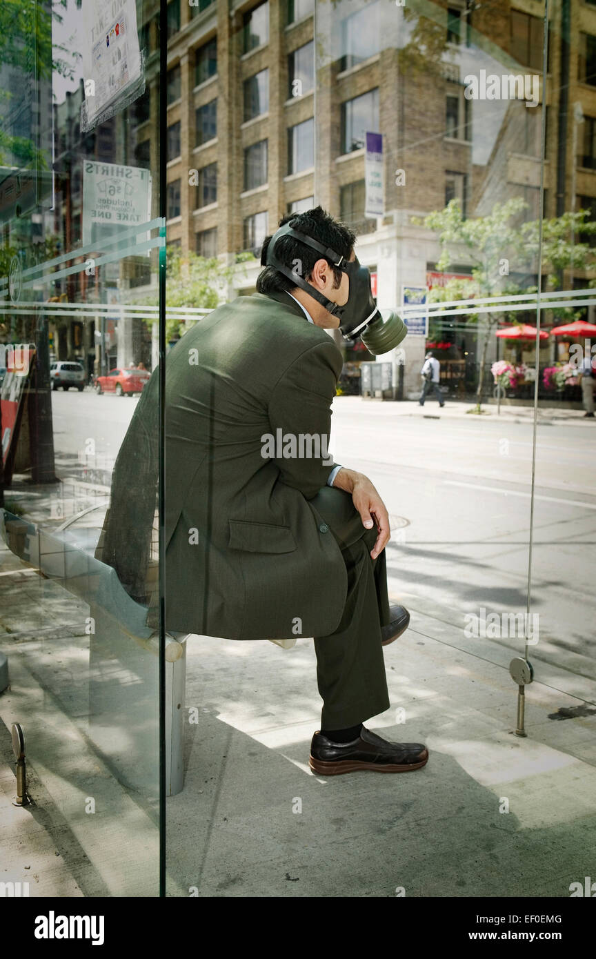 Man wearing a gas mask while waiting for the bus Stock Photo - Alamy