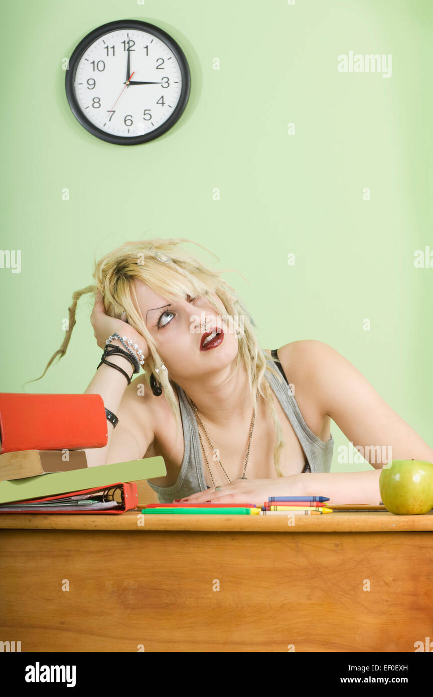 Bored teenage student sitting at desk Stock Photo - Alamy