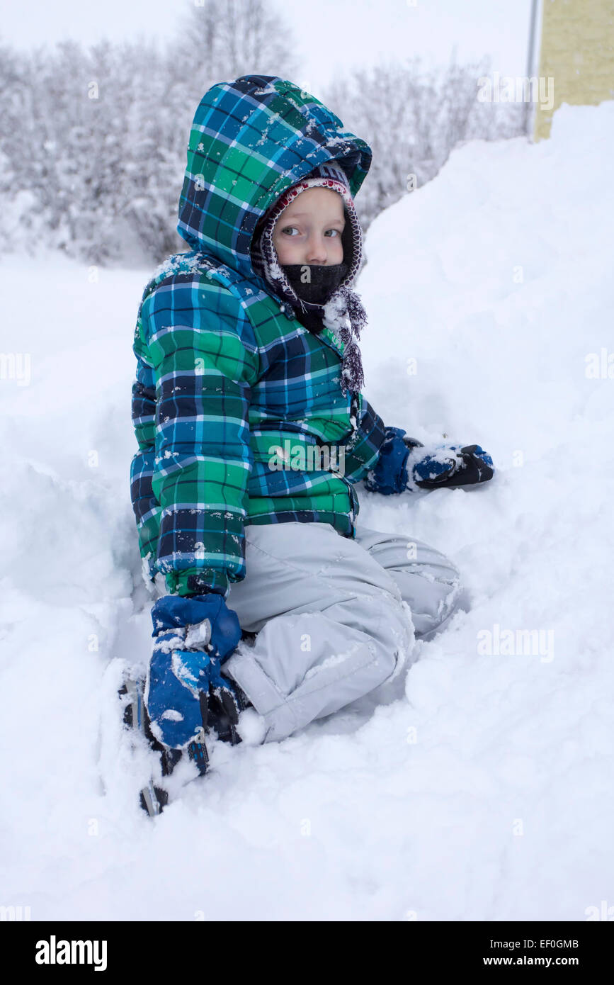 Young boy having fun in snow. Stock Photo