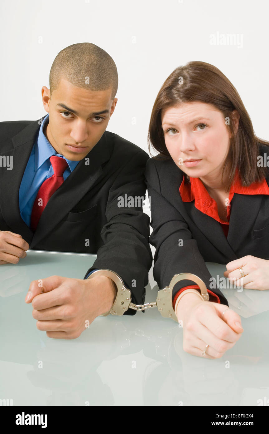 Colleagues handcuffed together Stock Photo