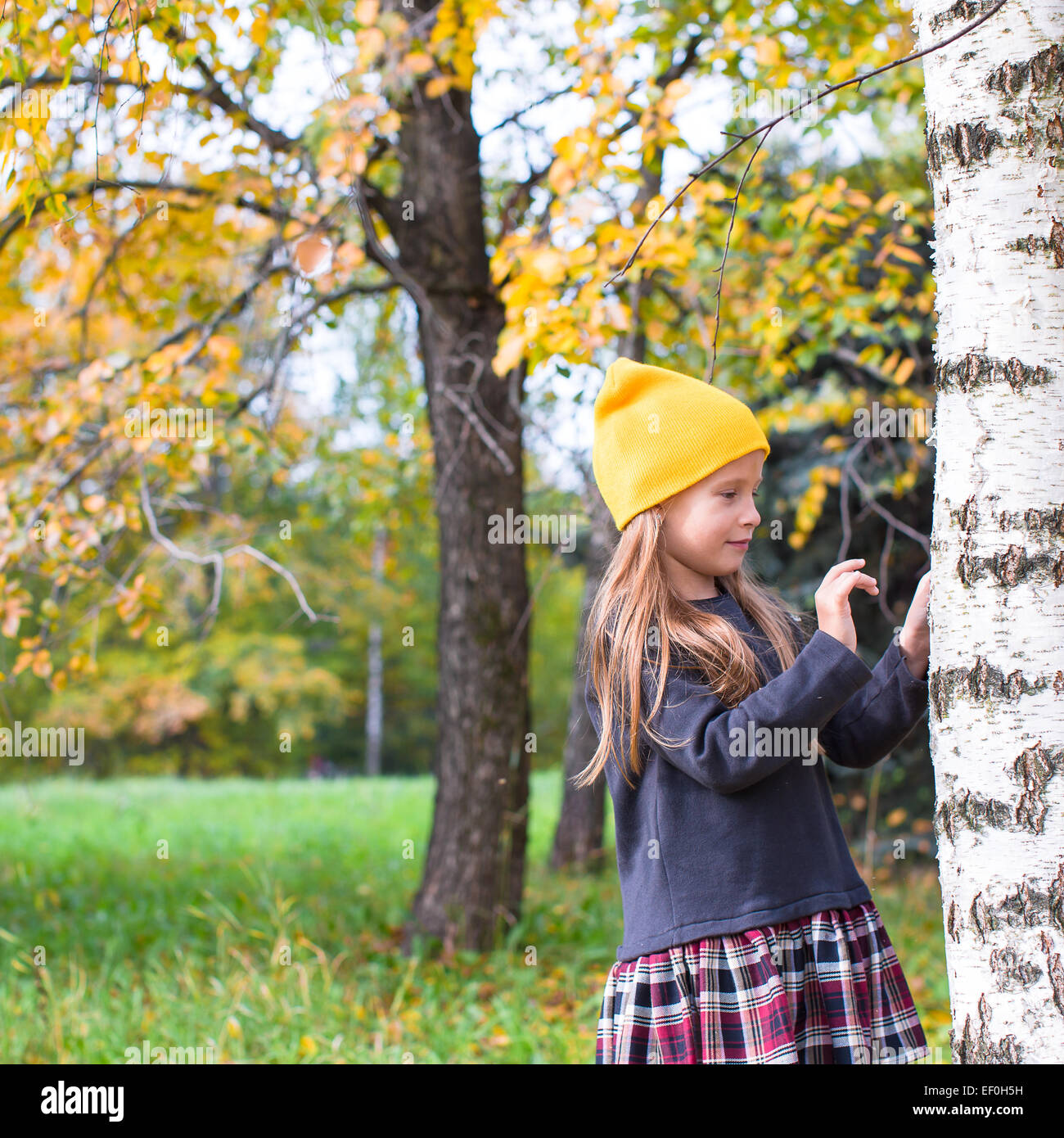 Little happy girl in autumn park outdoors Stock Photo - Alamy