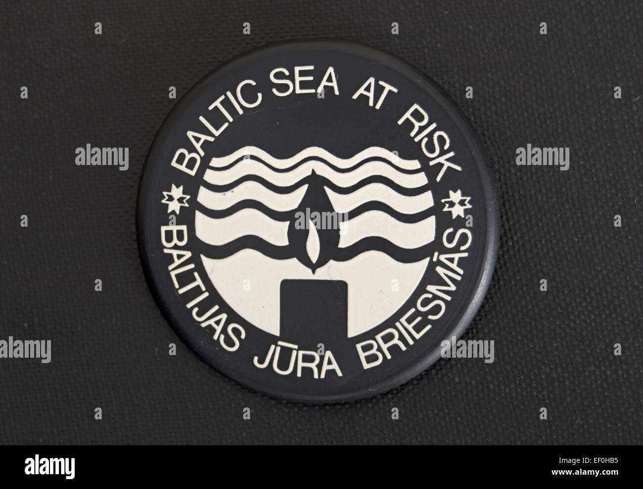 baltic sea at risk badge, with slogan also in latvian (or lettish), part of an environmental campaign of the 1980s Stock Photo