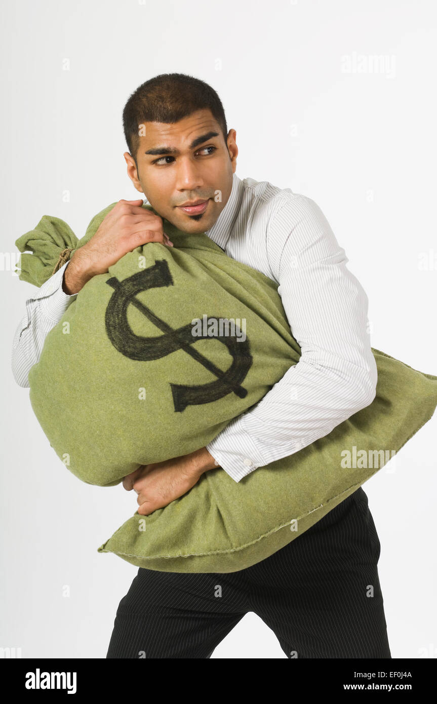 Man clutching a bag of money Stock Photo: 78075546 - Alamy