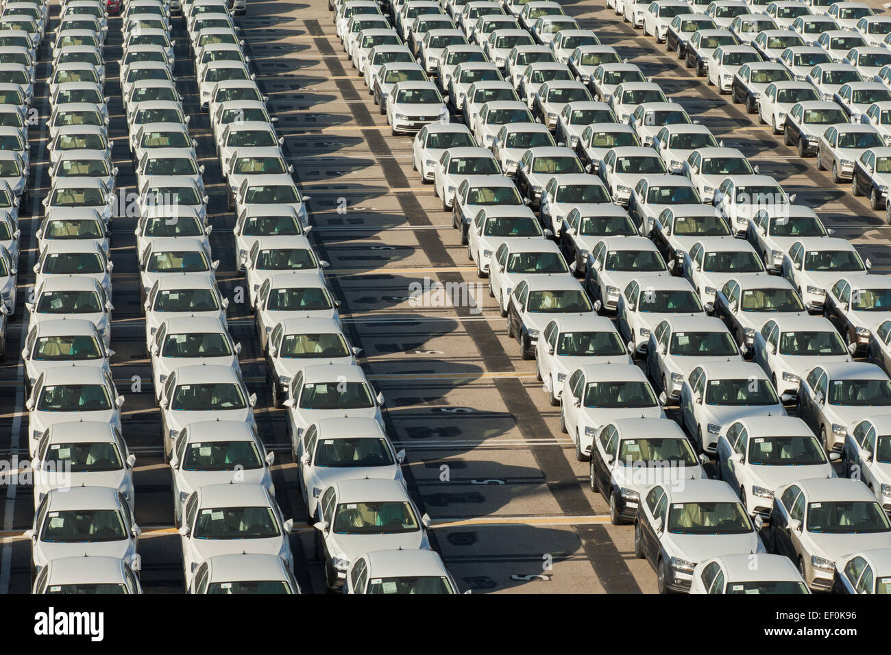 Rows of new cars parked in an international port Stock Photo