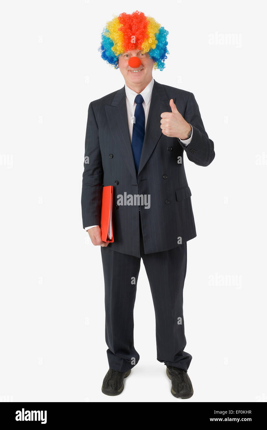 Businessman wearing clown nose and wig Stock Photo