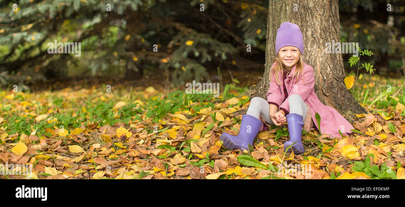 Little happy girl in autumn park outdoors Stock Photo - Alamy