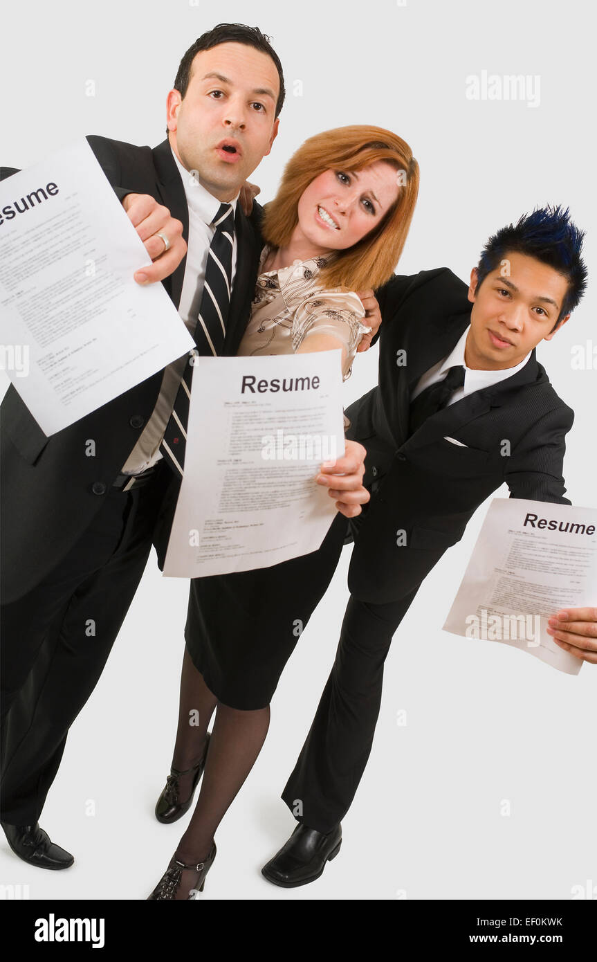 Three competitive people holding - Three Competitive People Holding Resumes EF0KWK