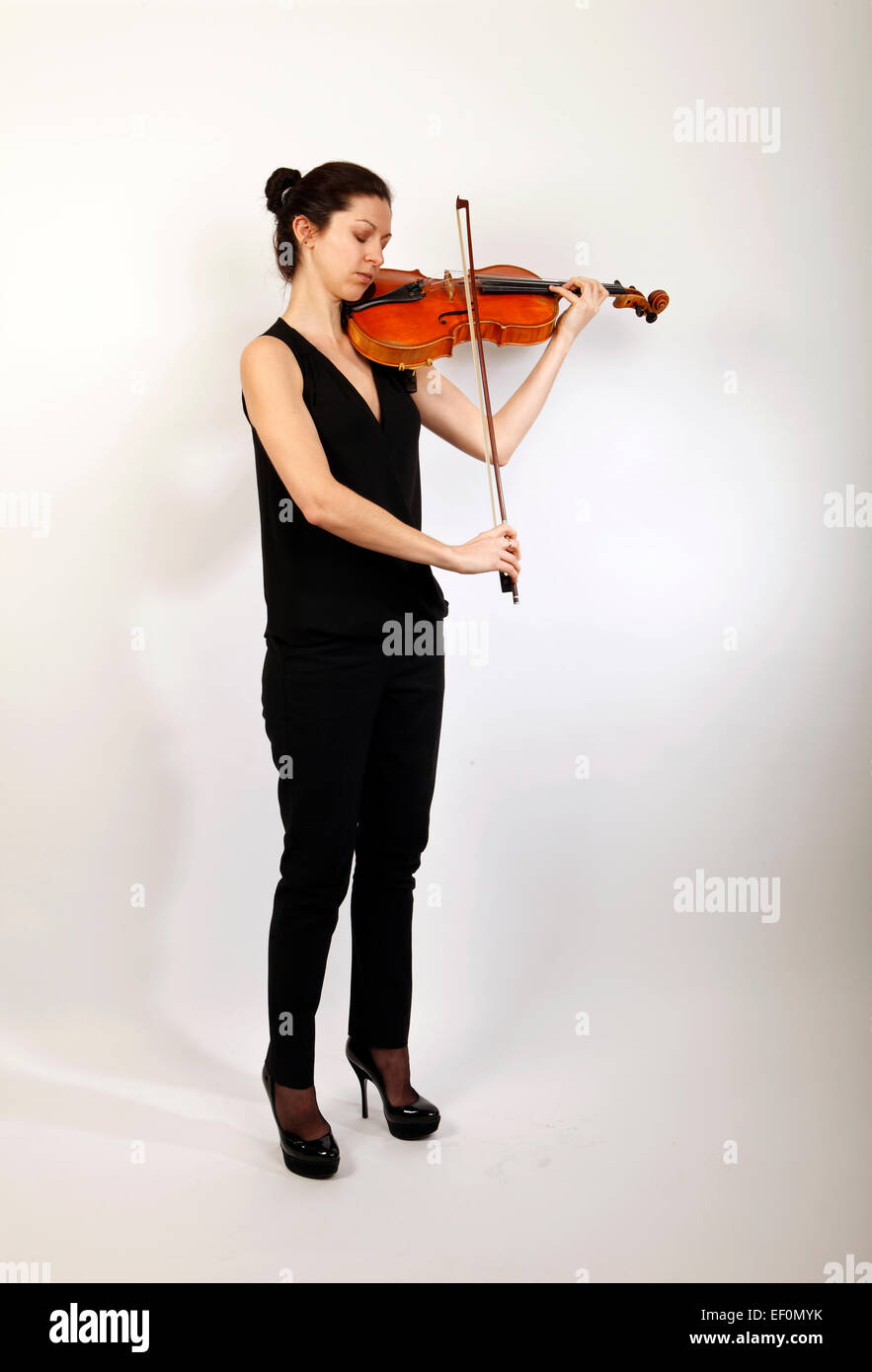 Viola player, playing her musical instrument Stock Photo