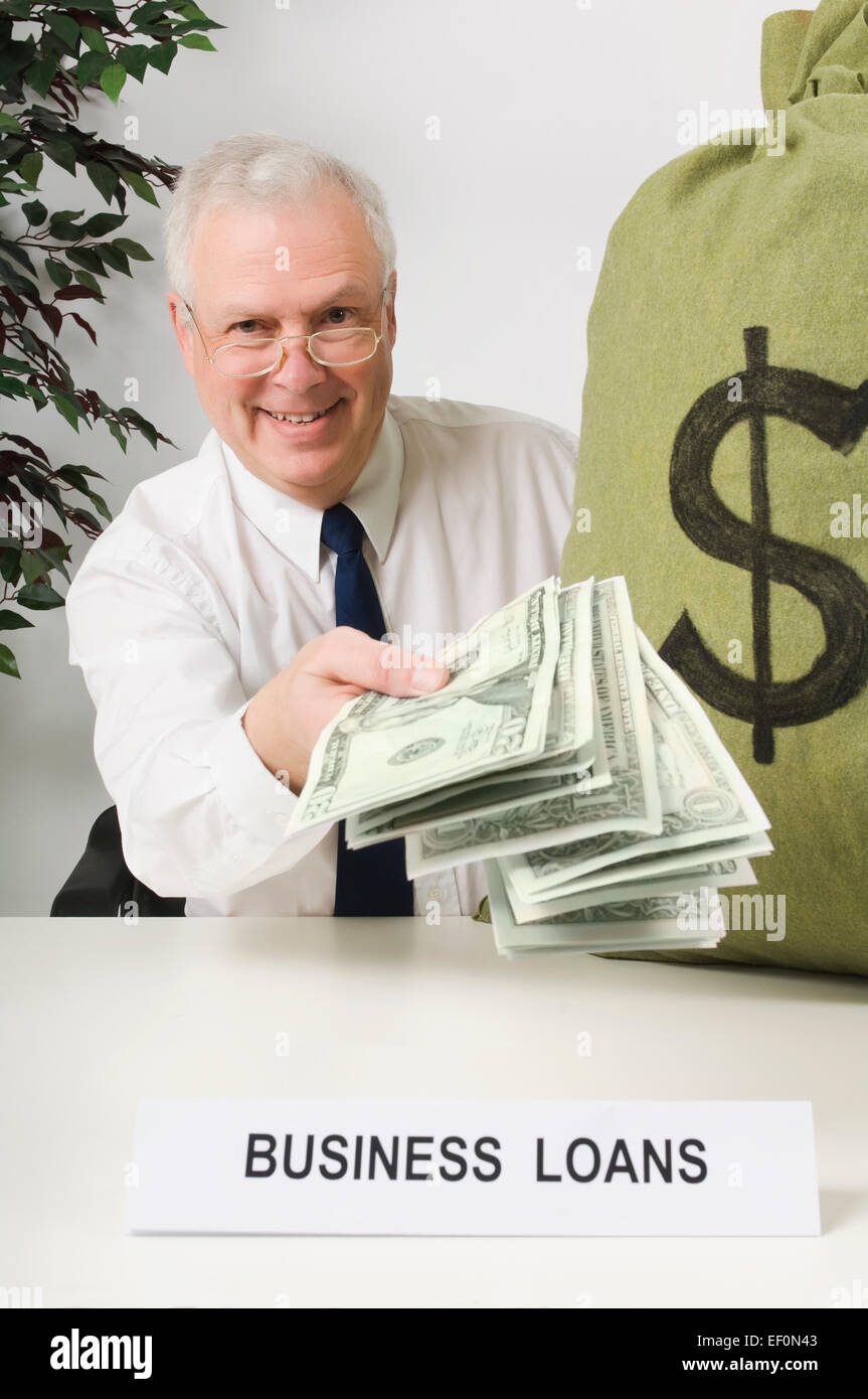 Businessman holding money bag hi-res stock photography and images - Alamy