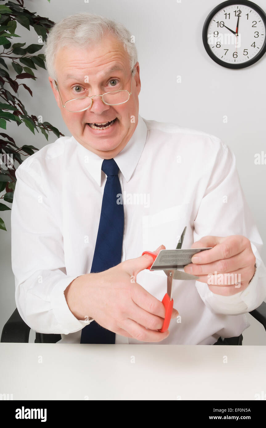 Businessman cutting up credit card Stock Photo Alamy