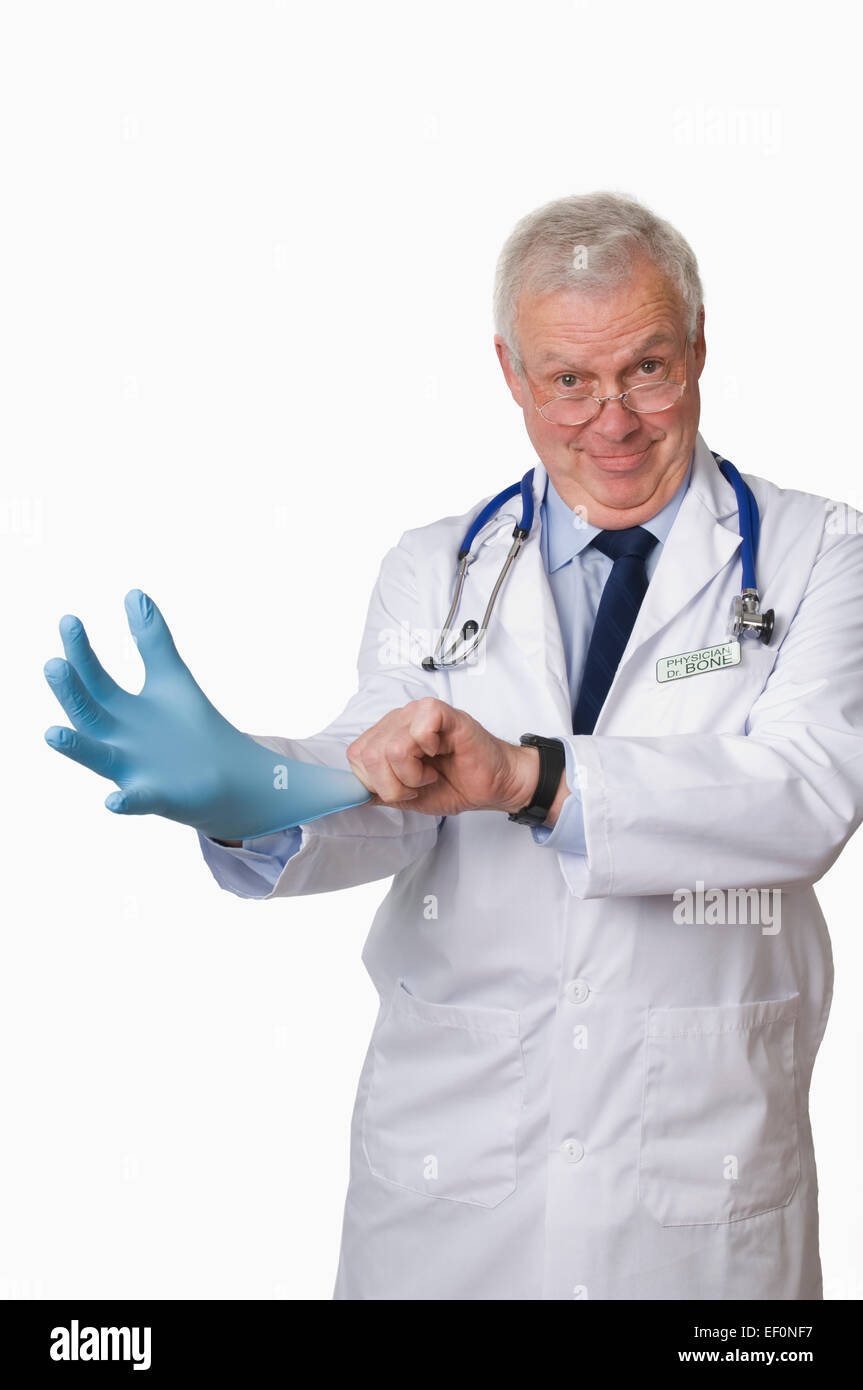 Doctor putting on blue latex glove Stock Photo