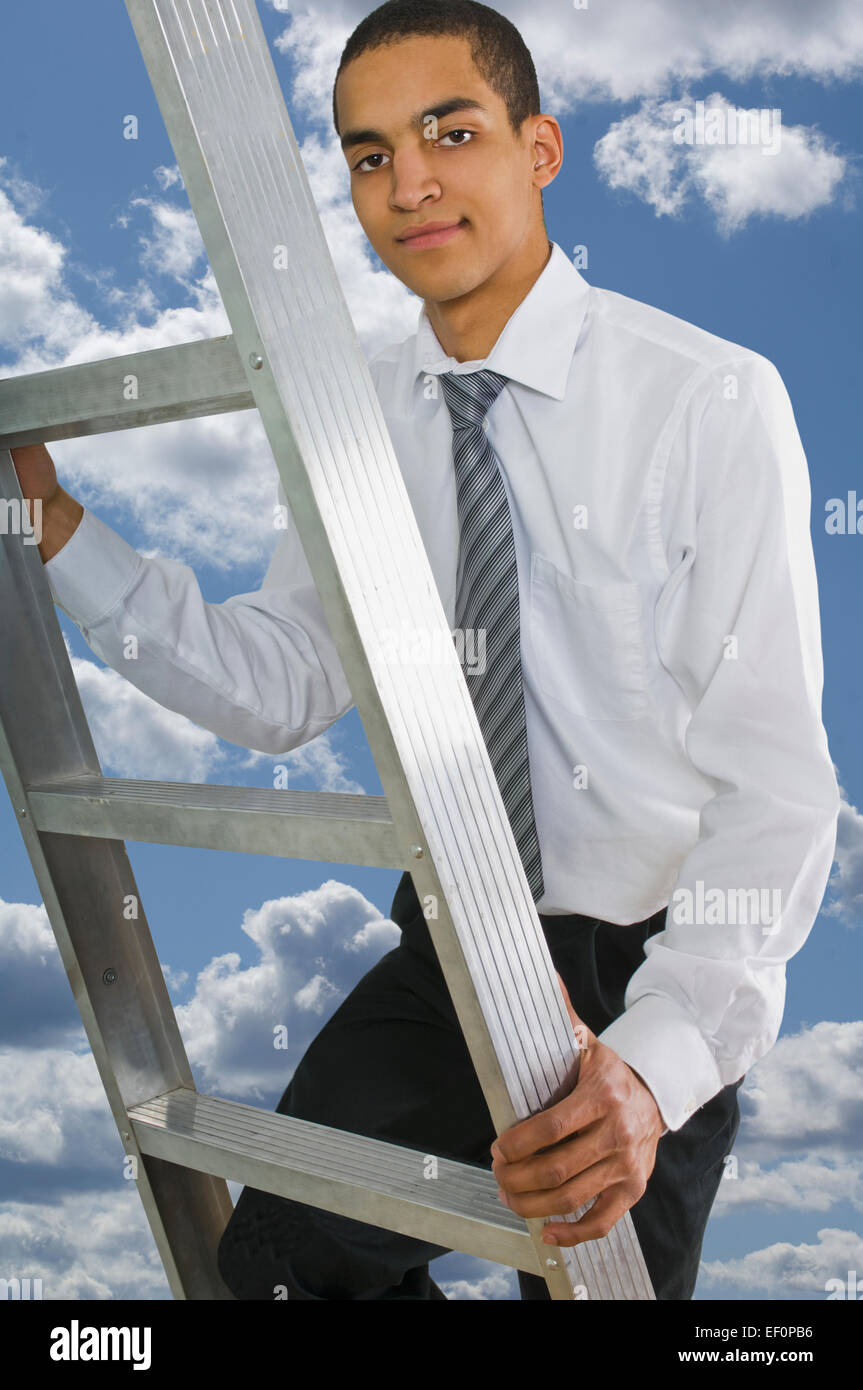 Man climbing ladder in the sky Stock Photo