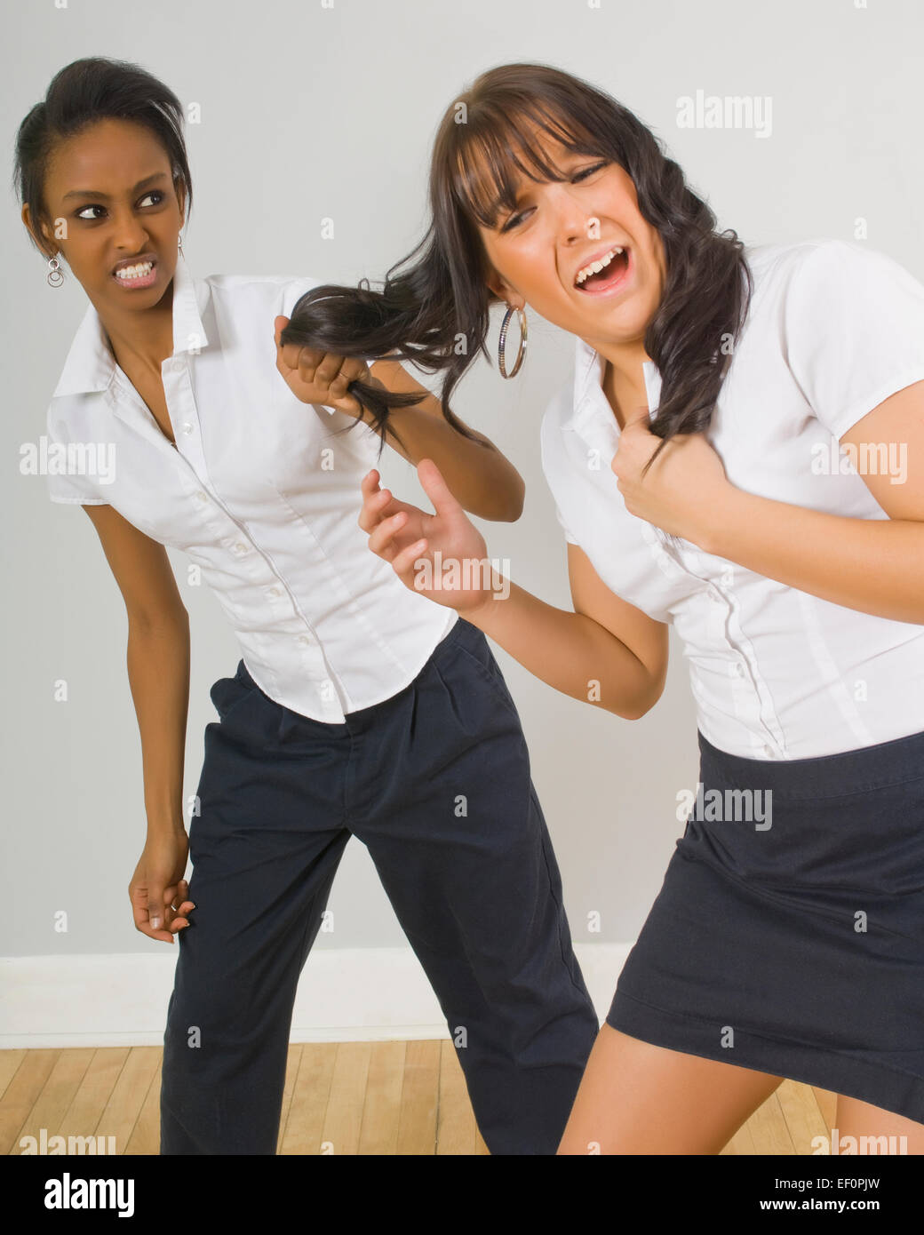 Girl pulling another girl's hair Stock Photo