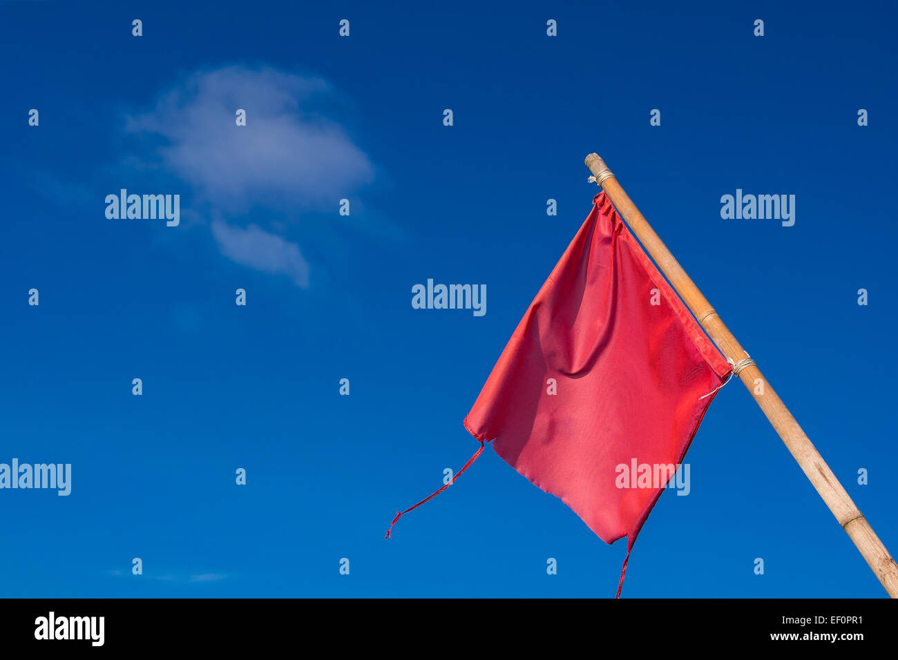 A red flag with blue sky. Stock Photo