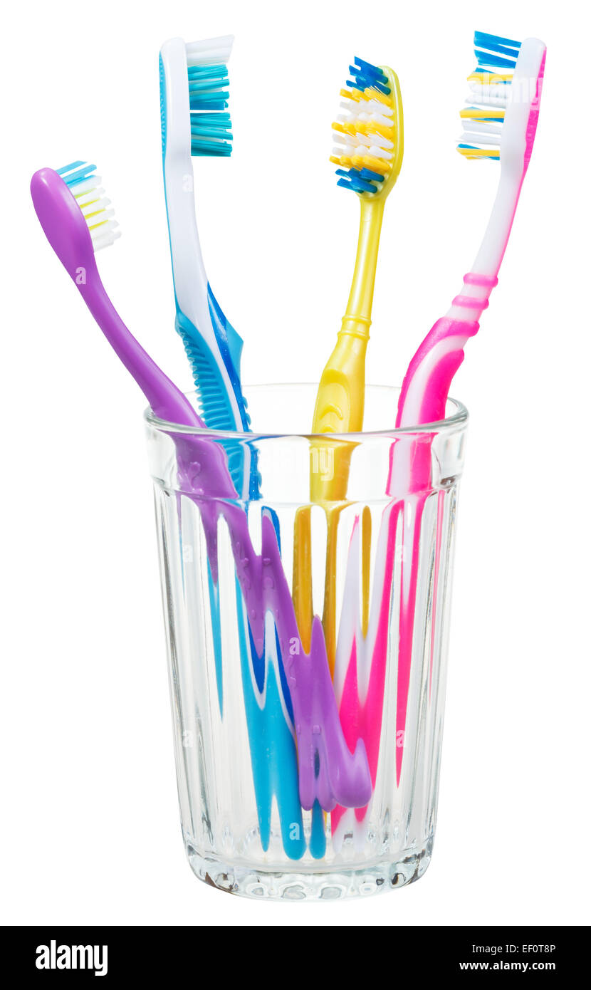 four toothbrushes in glass - family set of toothbrushes isolated on ...