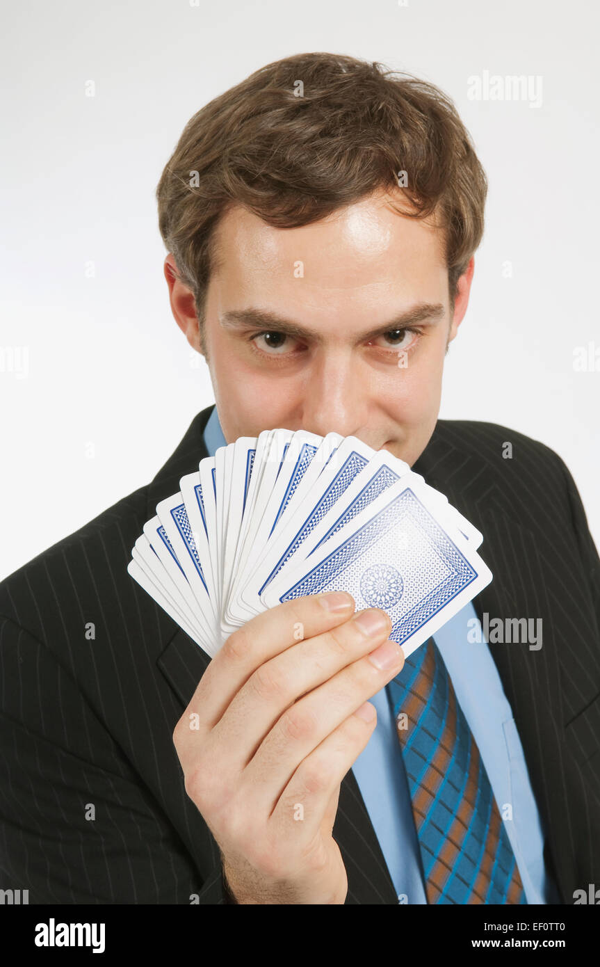 Businessman holding a deck of cards Stock Photo