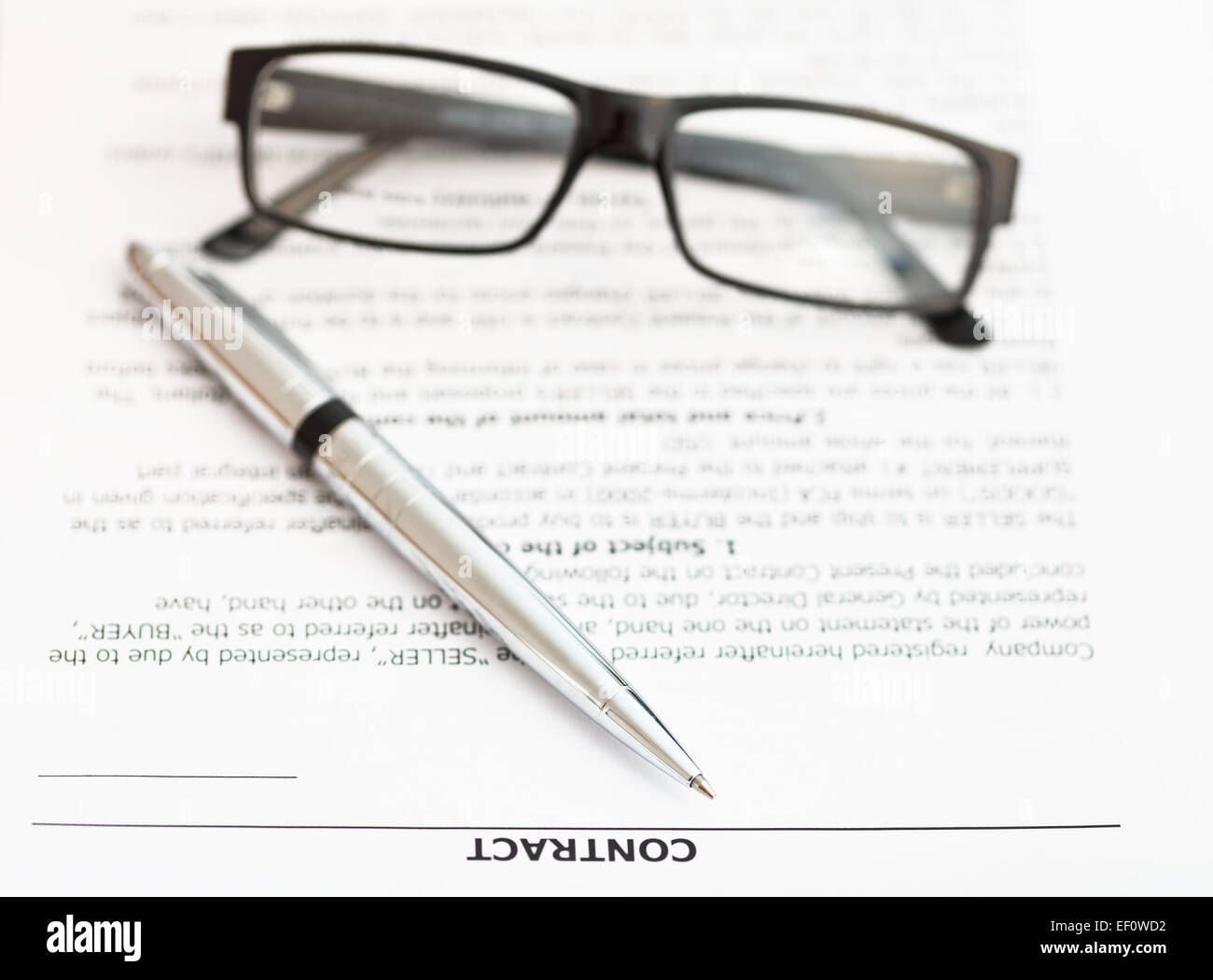 silver pen and eyeglasses on pages of sales contract Stock Photo