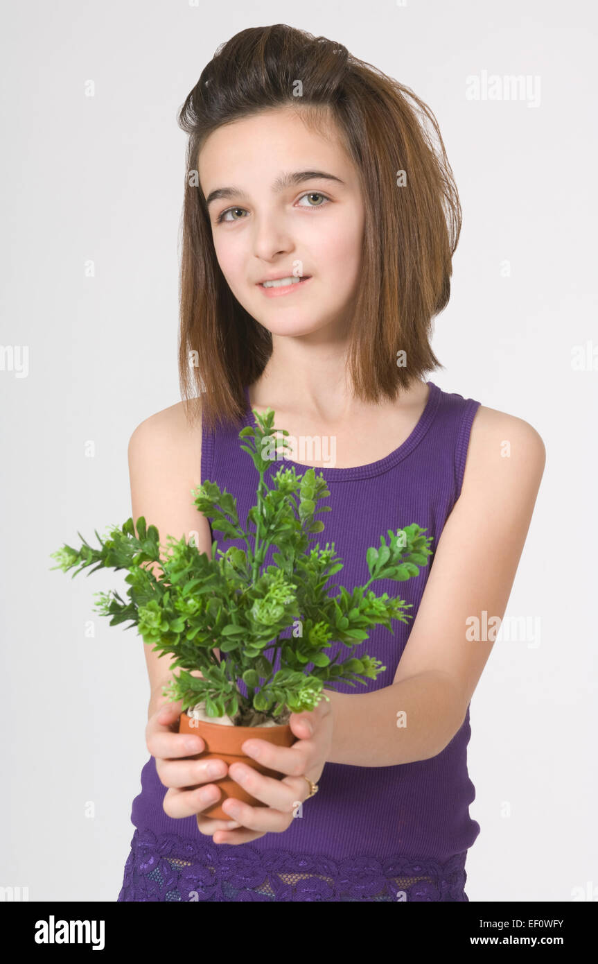 Young girl holding a potted plant Stock Photo - Alamy