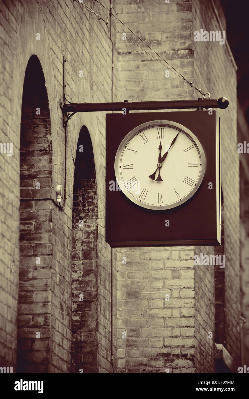 Urban historical architecture with vintage clock in street in London