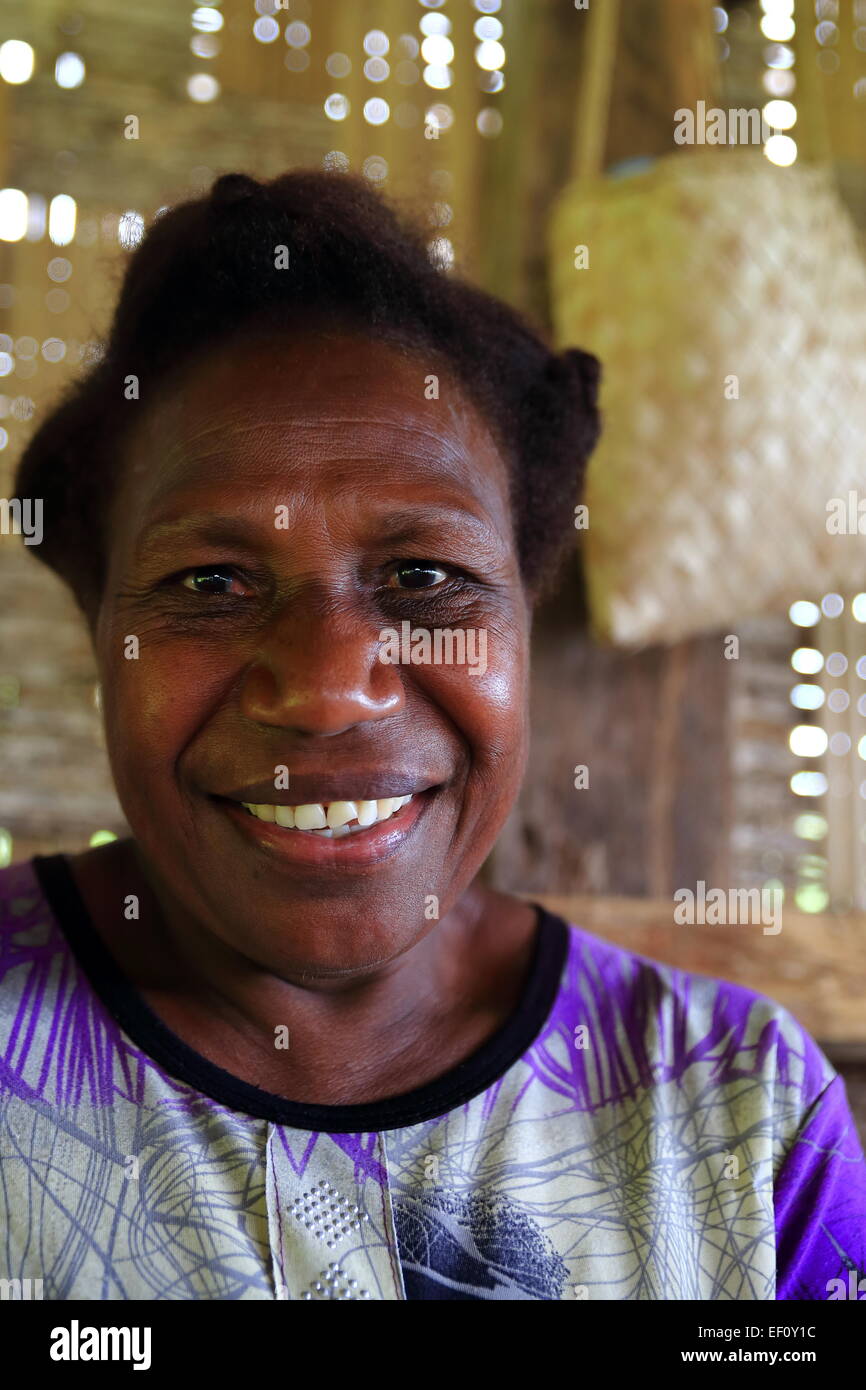 LONORORE,VANUATU-OCTOBER 15, 2014: Smiling lady selling vegetables and local food in a post Lonorore Airport on October 15, in P Stock Photo