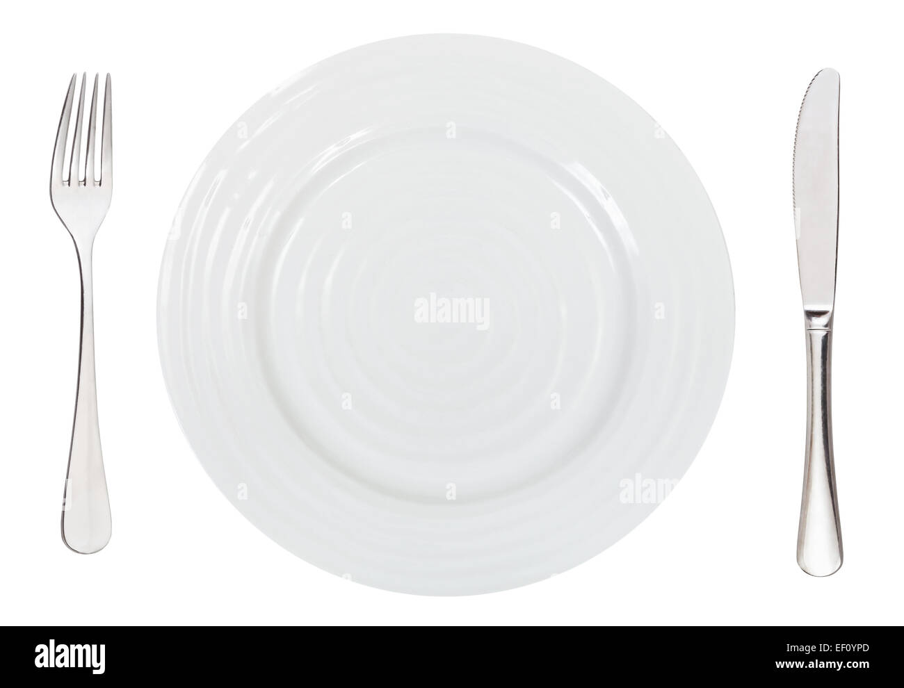 top view of empty white dinner plate with fork and knife isolated on ...