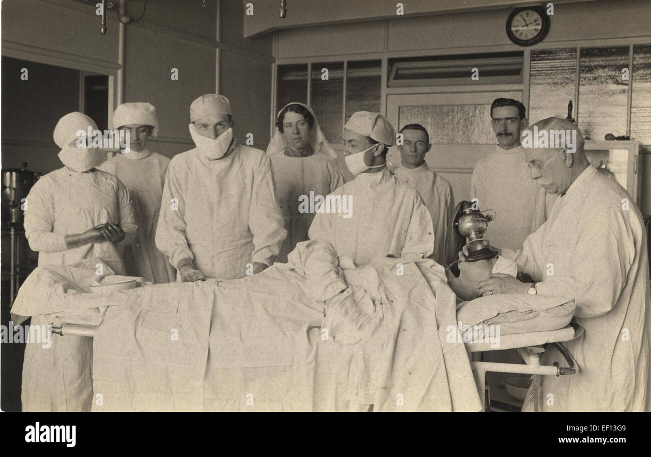 The 3rd floor theatre of King George Military Hospital, England, in 1915, was a site of medical advancements and military care during World War I. Dr. Barrington Ward and Dr. Lillian, shown in the photograph, were notable figures in military surgery and care. Stock Photo