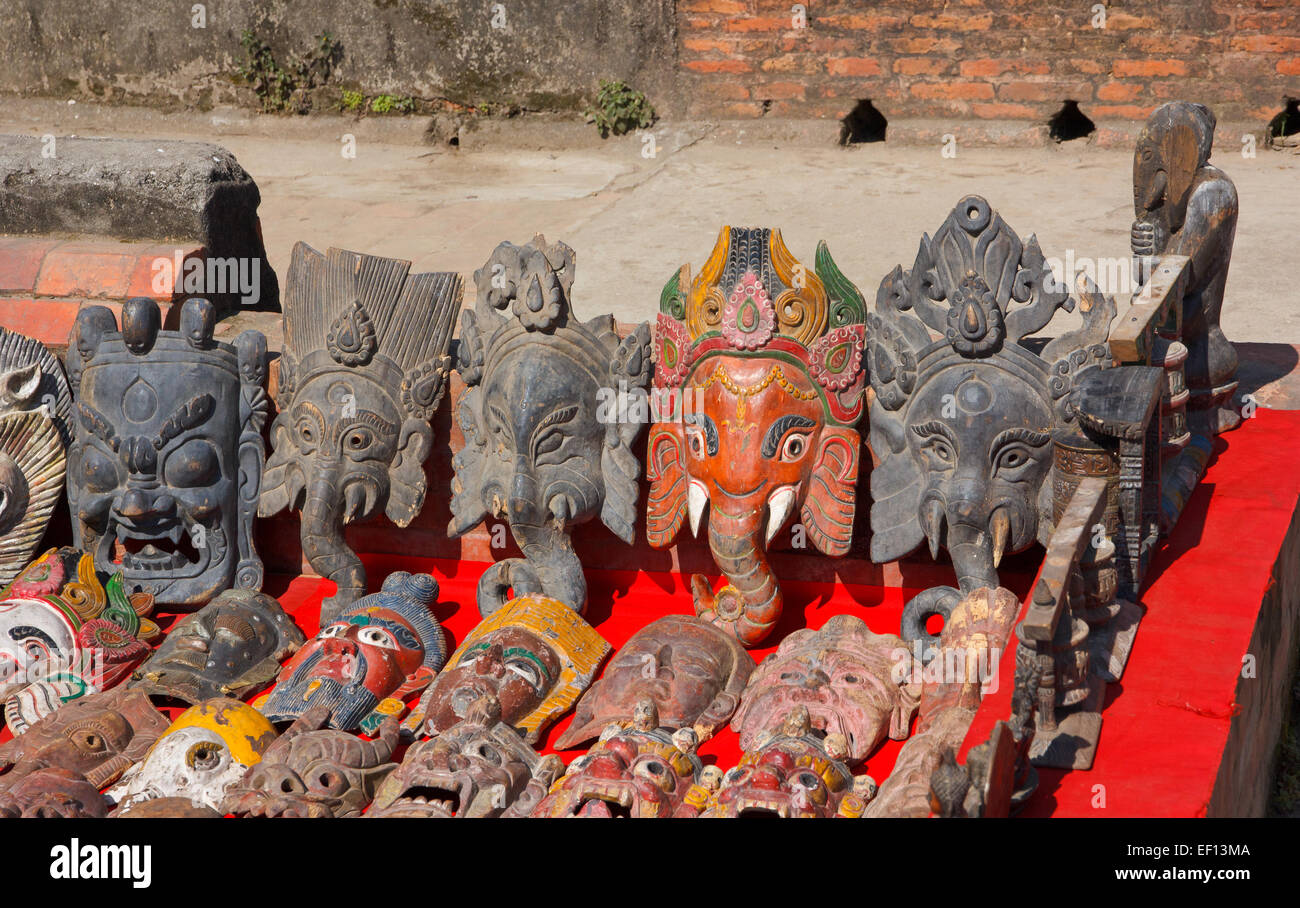 Hand carved wooden masks of Hindu god Ganesh at market in Patan, Nepal Stock Photo