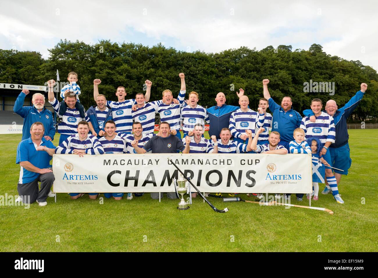 The Newtonmore team celebrate beating Kyles Athletic in the MacAulay Cup Final 2014 played at Mossfield, Oban. Stock Photo