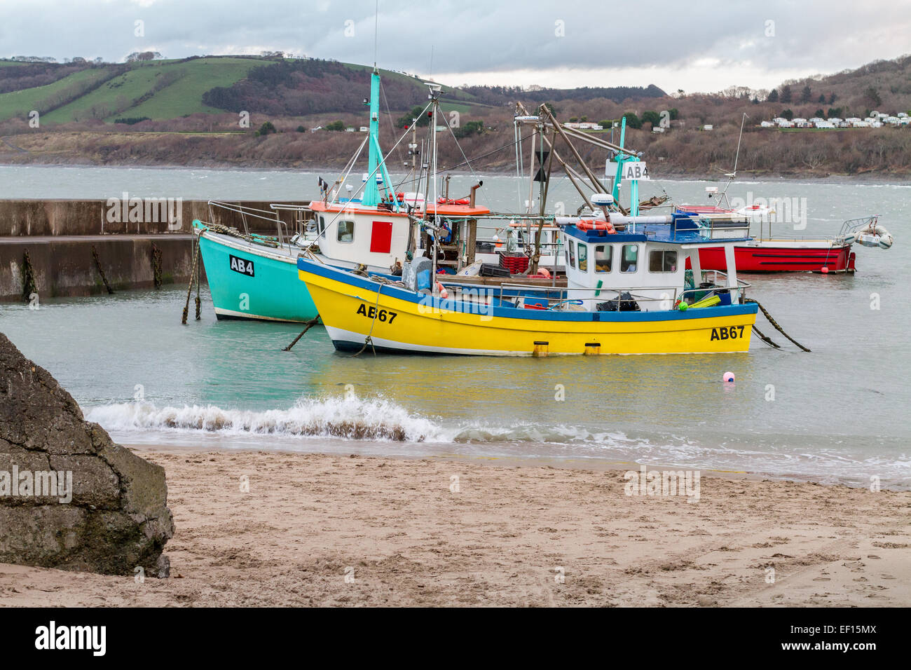 Two fishing boats moored in Newquay Harbour in Ceredigion on the West Coast of Wales.  Newquay is a small fishing village. Stock Photo