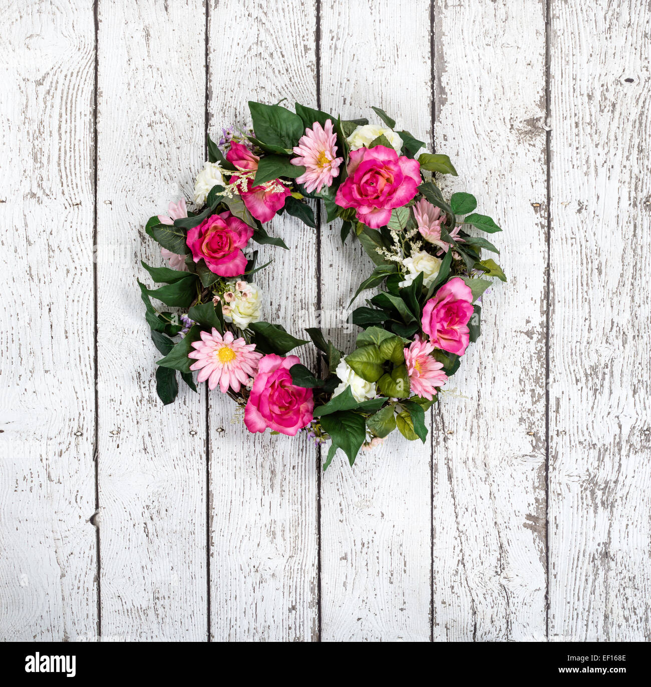 Flower wreath hanging against vintage white background Stock Photo
