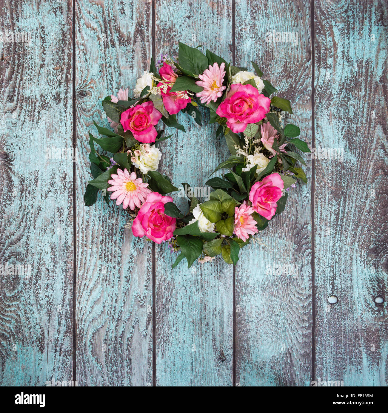 Floral wreath hanging against vintage green background Stock Photo