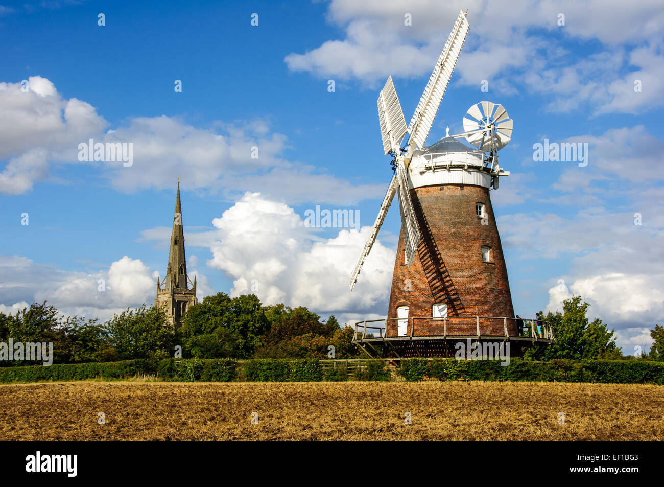 Thaxted Windmill with Church of St John The Baptist in background. Stock Photo