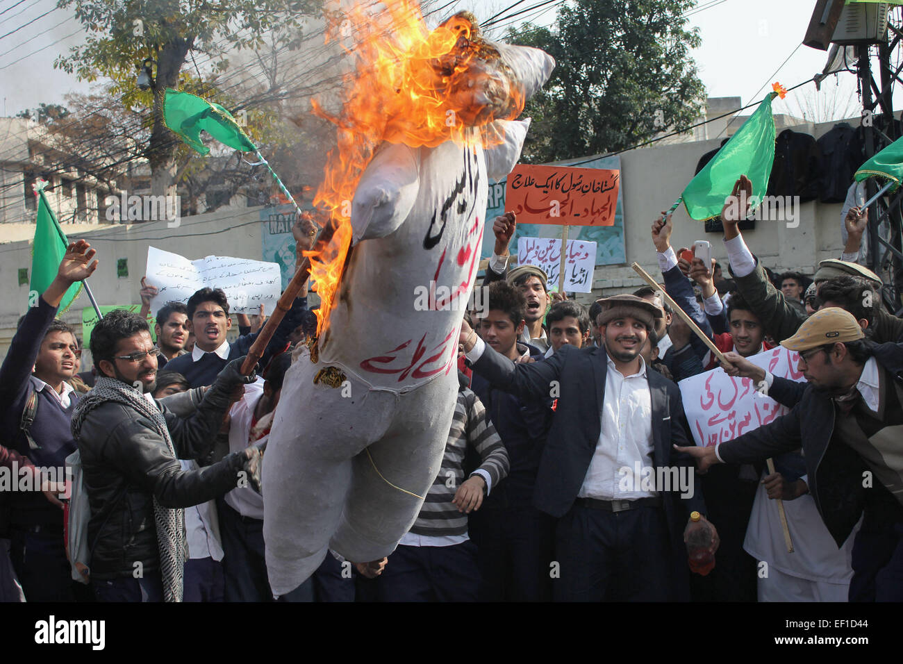 Pakistani students of (Punjab Polytechnic Institute ) burn an effigy of French cartoonists during a protest against publications of blasphemous caricatures in French magazine 'Charlie Hebdo' and showing their hearty devotion to Holy Prophet Muhammad (PBUH) during protest demonstration. Tens of thousands across Afghanistan, Pakistan and Muslim-majority Indian Kashmir took to the streets for southern Asia's biggest protests against satirical magazine Charlie Hebdo's cartoon portrayal of the Prophet Mohammed. © Rana Sajid Hussain/Pacific Press/Alamy Live News Stock Photo