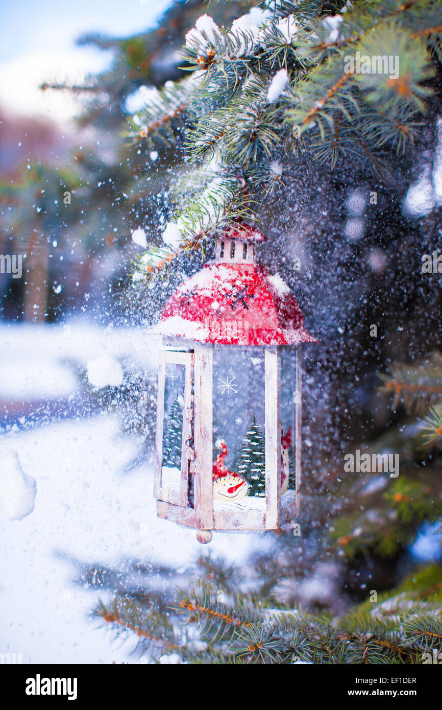 Christmas lantern with snowfall hanging on a fir branch Stock Photo - Alamy